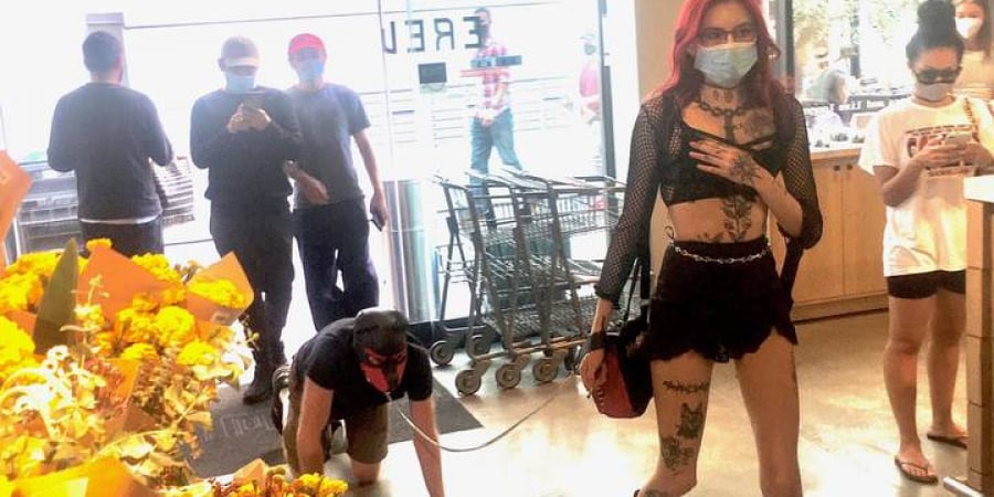 Dominatrix pictured walking sub on a lead through crowded supermarket article image